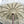 Handmade white macrame Balinese umbrella with wooden pole and decorative fringe