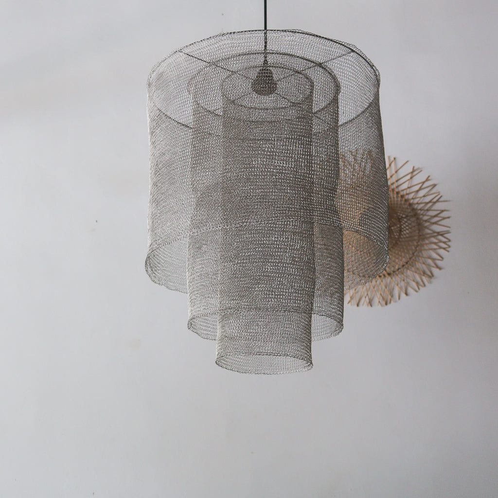 Mesh pendant light fixture on a plain wall