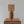 Handcrafted wooden table lamp with a rattan shade on carved wooden furniture