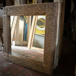 Hand-carved wooden mirrors with intricate Balinese patterns, rustic home decor