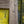 Corner of a rustic wooden frame against a textured yellow wall, handmade home decor