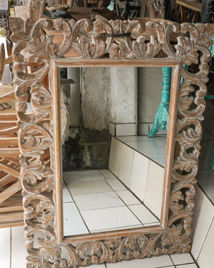 Hand-carved Balinese wooden mirror with intricate floral frame, rustic home decor