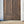Hand-carved Balinese wooden double door with floral patterns, outdoor setting