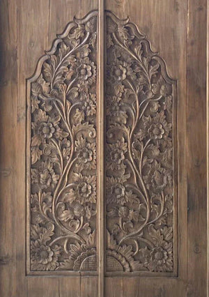 Hand-carved Balinese wooden door with intricate floral pattern, artisan home decor