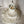 Handmade beaded seashell chandelier with layered design on a neutral background.