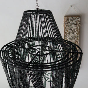 Unique black beaded chandelier, handcrafted in Bali, perfect for elegant home decor.
