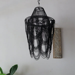 Elegant black beaded chandelier lamp handcrafted in Bali, showcasing intricate design and unique motifs.