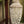 Handmade seashell chandelier mobile with intricate shell patterns in a natural outdoor setting