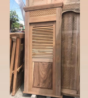 Hand-carved Balinese wooden door with louvered panel and intricate top detailing