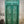 Green vintage hand-carved Balinese wooden door with intricate floral designs