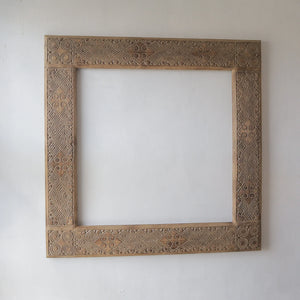 Hand-carved ethnic mirror frame from Bali, Indonesia, featuring unique motifs and handmade wood design.
