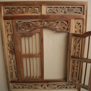 Hand-carved wooden mirror frame with intricate Balinese floral design
