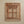 Hand-carved wooden mirror frame with floral Balinese design against a beige wall
