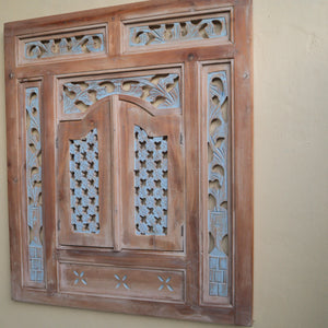 Hand-carved Balinese wooden window frame with intricate floral and geometric designs