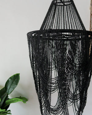 Black beaded chandelier showcasing intricate craftsmanship, ideal for elegant home decor.