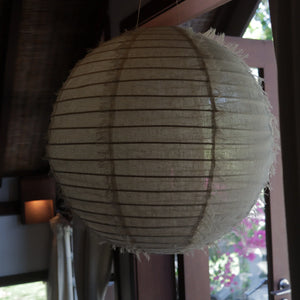 Bohemian linen ceiling light with woven texture hanging in a modern interior room