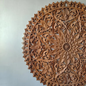 Hand-carved wooden mandala wall art with intricate floral and leaf patterns