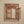 Hand-carved Balinese wooden frame with floral patterns and open side panel on beige wall