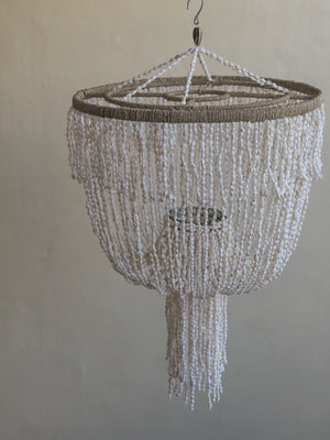 Handmade seashell chandelier with cascading white beads and natural twine accents