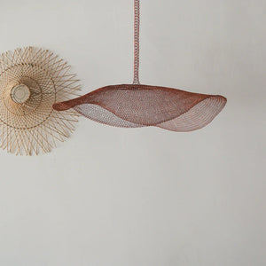 Handcrafted wire pendant lamp and woven wall decor on white background
