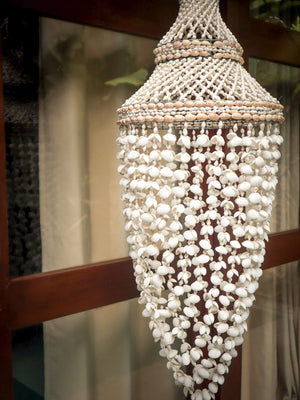 Handmade seashell ceiling pendant lamp with natural woven shell strands, coastal decor