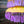 Yellow Balinese decorative parasol with purple fringe tassels and ornate pattern, outdoor decor