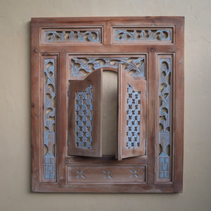 Hand-carved wooden wall mirror frame with intricate Balinese floral patterns