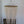 Handmade Balinese seashell chandelier with cascading white bead strands against white wall