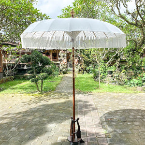 White Balinese parasol with fringe, outdoor garden decoration, handcrafted detail