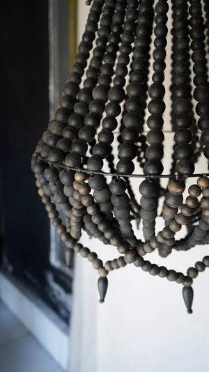 Handcrafted black wooden beaded chandelier with natural finish, modern boho decor