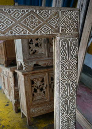 Hand-carved Balinese wooden furniture with intricate geometric and floral patterns