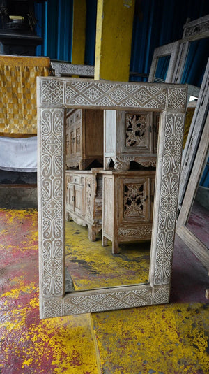 Hand-carved Balinese mirror with intricate wood pattern, rustic finish, and artisan detail