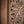 Hand-carved Balinese wood door detail with intricate floral and scrollwork patterns.
