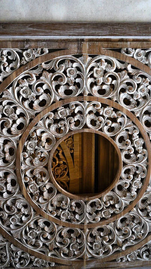 Hand-carved Balinese wood panel with intricate floral and circular patterns
