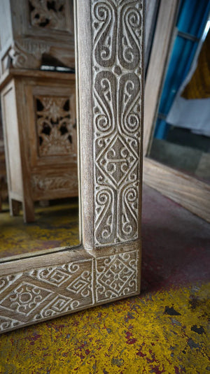 Hand-carved Balinese wood mirror frame with intricate floral and geometric patterns