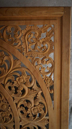 Hand-carved Balinese wood door panel with intricate floral and leaf patterns