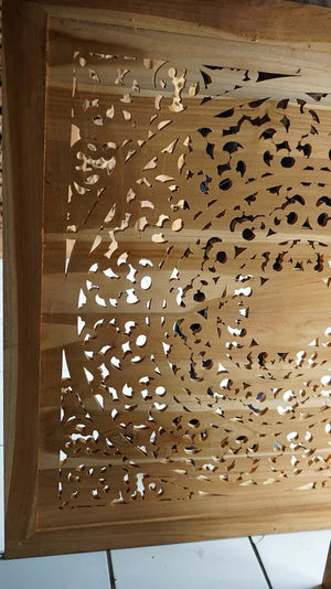Hand-carved wooden panel with intricate floral and geometric Balinese patterns