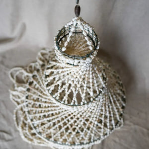 Handmade seashell chandelier with intricate woven pattern, coastal boho home decor