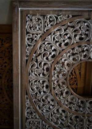 Hand-carved Balinese wooden panel with intricate floral and vine motifs