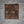 Handmade teak wood trivet with geometric pattern on neutral fabric background