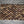 Rectangular hand-carved teak wood mosaic panel with natural brown tones on fabric background