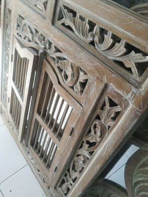 Hand-carved Balinese wood door panel with intricate floral and geometric patterns