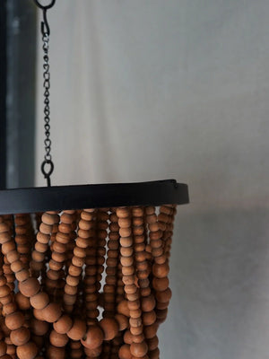 Handmade wooden beaded chandelier with black frame, hanging on metal chain