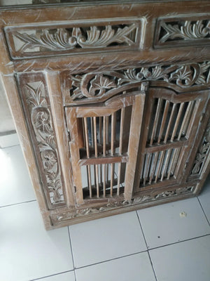 Hand-carved Balinese wooden door with intricate floral and geometric patterns