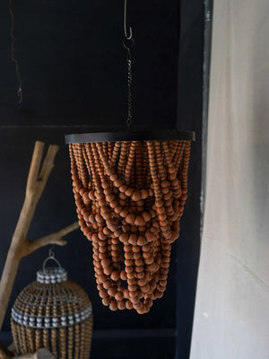 Handmade wooden bead chandelier with cascading bohemian design, hanging indoors.