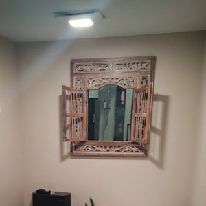 Hand-carved Balinese wooden mirror with open shutter doors, wall-mounted decor
