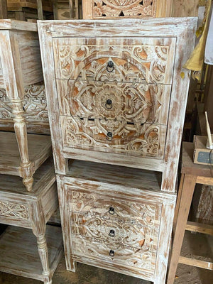 Hand-carved wooden nightstands with intricate Balinese floral patterns and distressed finish