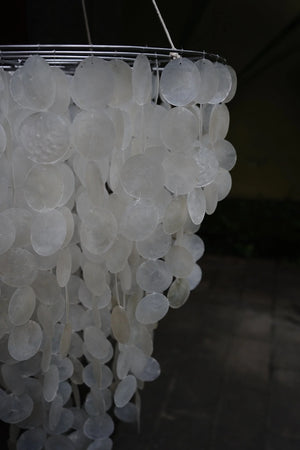 Handmade capiz shell chandelier with round translucent discs hanging in layers
