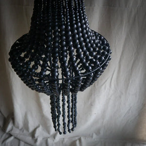 Handmade black beaded chandelier with cascading strands and boho home decor style