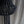 Black beaded chandelier with cascading strands against a neutral fabric backdrop